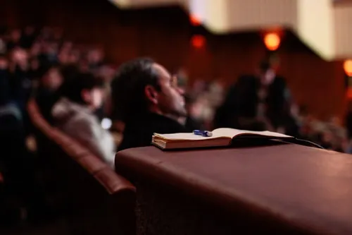 Pen and notebook in a presentation hall